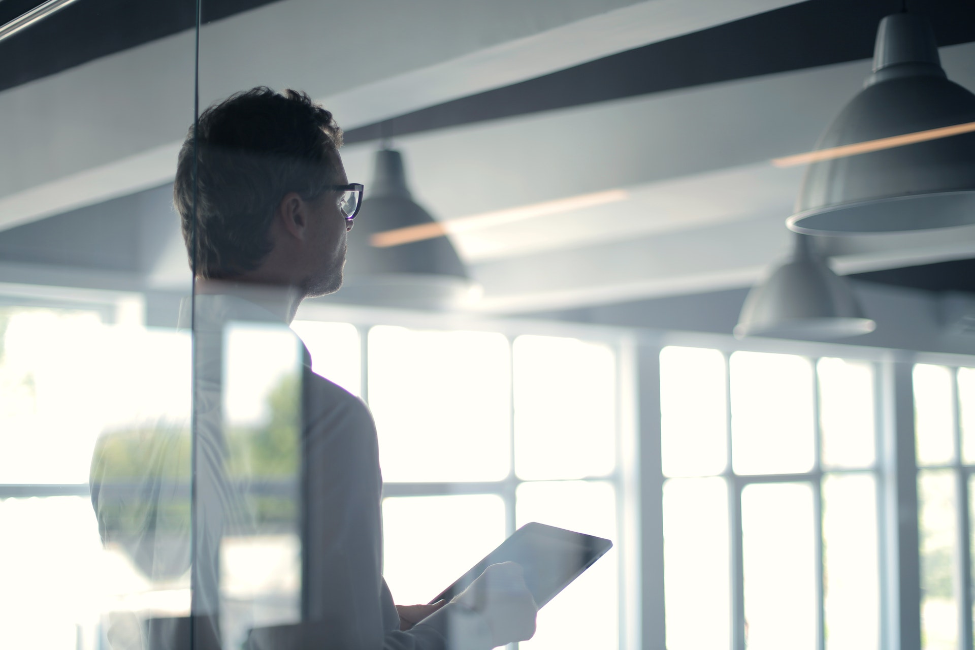 formal man with tablet giving presentation in office info-90